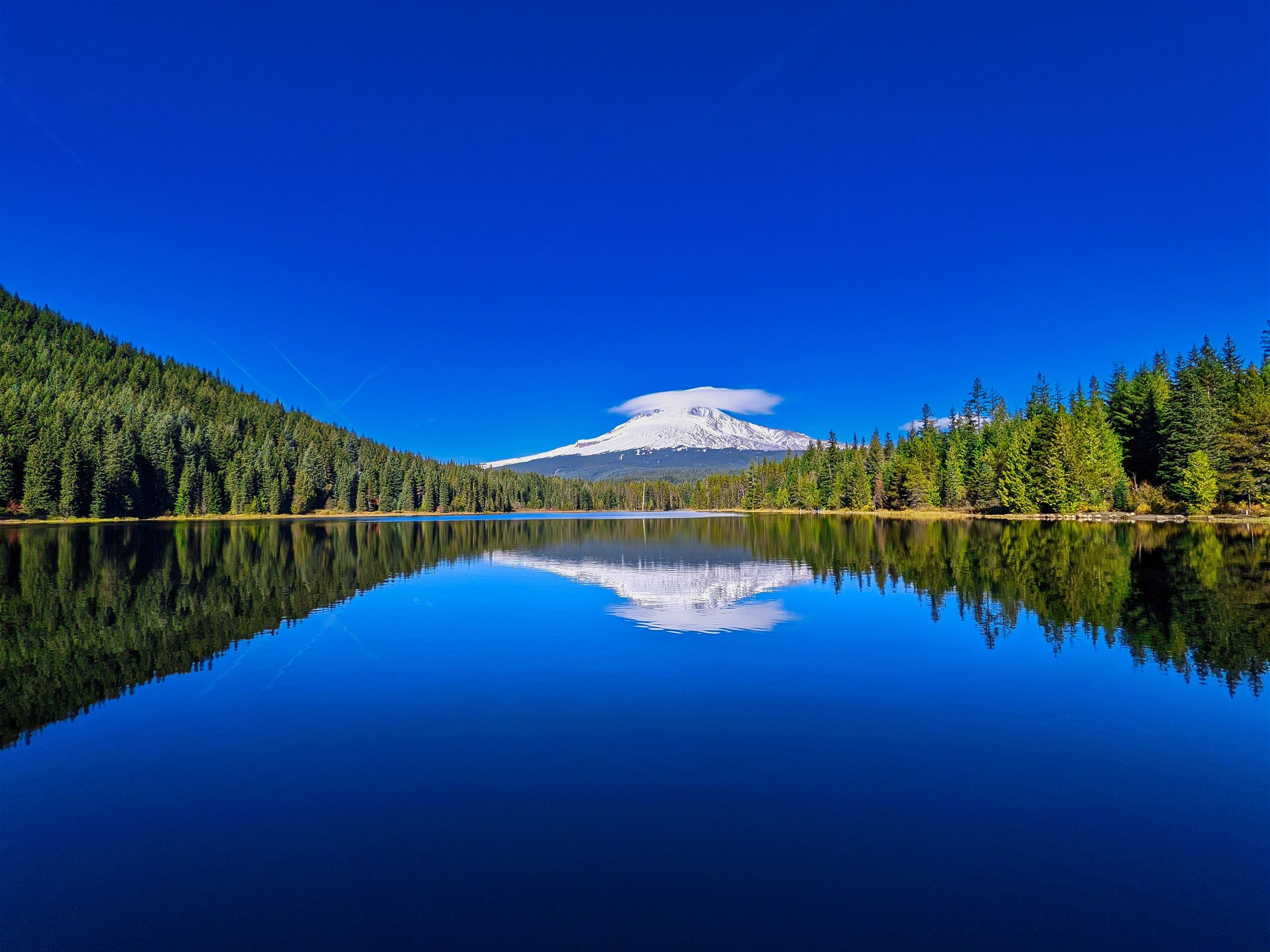 A mountain lake reflecting a snow-capped peak